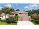 Beautiful two-story home with a three-car garage and tropical landscaping at 7915 Kavanagh Ct, Sarasota, FL 34240