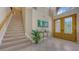 Bright foyer featuring tile floors, staircase, and a beautiful stained glass door at 7915 Kavanagh Ct, Sarasota, FL 34240