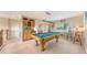 Spacious game room featuring pool table, bar area, and window views at 7915 Kavanagh Ct, Sarasota, FL 34240