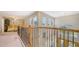 Hallway with natural lighting and views of the entry way and living space below at 7915 Kavanagh Ct, Sarasota, FL 34240