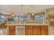 Spacious kitchen with wood cabinets, stainless steel appliances, and an open layout to the living area at 7915 Kavanagh Ct, Sarasota, FL 34240