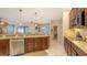 Kitchen with stainless steel appliances, wooden cabinets, and a view to the dining and living areas at 7915 Kavanagh Ct, Sarasota, FL 34240