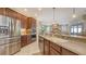 Well-lit kitchen featuring stainless steel appliances, granite countertops, and wood cabinetry at 7915 Kavanagh Ct, Sarasota, FL 34240
