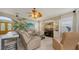 Cozy living room with entertainment center, comfortable seating and a ceiling fan at 7915 Kavanagh Ct, Sarasota, FL 34240