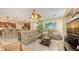 Inviting living room with tile flooring, tan sofas, an entertainment center, and a ceiling fan at 7915 Kavanagh Ct, Sarasota, FL 34240