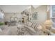 Bright living room featuring a glass coffee table, comfortable seating, and elegant decor at 7915 Kavanagh Ct, Sarasota, FL 34240