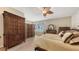 Spacious bedroom featuring hard wood flooring, wooden furniture, and ample natural light at 7915 Kavanagh Ct, Sarasota, FL 34240
