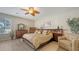 Bedroom with wood-look flooring, ceiling fan, and beautiful furnishings at 7915 Kavanagh Ct, Sarasota, FL 34240