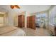 Sunlit bedroom featuring wood-look floors, wooden furniture, and a lovely view at 7915 Kavanagh Ct, Sarasota, FL 34240