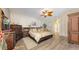 Well-lit bedroom featuring wooden floors, ceiling fan, and ample closet space at 7915 Kavanagh Ct, Sarasota, FL 34240