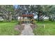Enjoy outdoor dining at this pergola covered table set amongst the lush landscaping at 7915 Kavanagh Ct, Sarasota, FL 34240