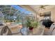 Enjoy outdoor dining and relaxation on this screened patio with a pool, hot tub, and a mounted television at 7915 Kavanagh Ct, Sarasota, FL 34240