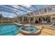 The screened-in pool, hot tub, and patio create a relaxing outdoor oasis for leisure and entertainment at 7915 Kavanagh Ct, Sarasota, FL 34240