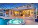 The screened pool is equipped with dining spaces and an outdoor kitchen area for entertaining at 7915 Kavanagh Ct, Sarasota, FL 34240