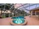 The screened-in pool and hot tub offer a tranquil escape in a private outdoor space at sunset at 7915 Kavanagh Ct, Sarasota, FL 34240