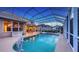 The screened pool, spa, and dolphin statue create an outdoor oasis for leisure and enjoyment at 7915 Kavanagh Ct, Sarasota, FL 34240