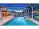 The screened pool with spa and volleyball court combines recreation with outdoor living at 7915 Kavanagh Ct, Sarasota, FL 34240
