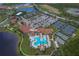 Aerial view of the beautiful community featuring a pool, tennis courts and clubhouse at 10054 Crooked Creek Dr # 201, Venice, FL 34293
