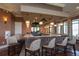 Beautiful clubhouse bar with seating and stylish pendant lighting at 10054 Crooked Creek Dr # 201, Venice, FL 34293