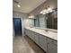 Large bathroom features double sinks, tiled floors and shower at 10054 Crooked Creek Dr # 201, Venice, FL 34293