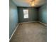 Bright bedroom featuring carpeted floors, a ceiling fan and large windows for ample natural light at 10054 Crooked Creek Dr # 201, Venice, FL 34293