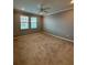 Bright bedroom features two windows and a ceiling fan at 10054 Crooked Creek Dr # 201, Venice, FL 34293
