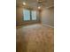 Bright bedroom with carpet, two windows and a ceiling fan at 10054 Crooked Creek Dr # 201, Venice, FL 34293