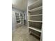 Walk-in closet featuring shelving, drawers, and storage at 10054 Crooked Creek Dr # 201, Venice, FL 34293