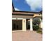 Home's exterior showing open garage, brick driveway and well maintained landscaping and exterior at 10054 Crooked Creek Dr # 201, Venice, FL 34293