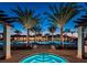Relaxing hot tub near a pool, lit up at night by surrounding landscape lighting at 10054 Crooked Creek Dr # 201, Venice, FL 34293
