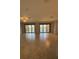 Large living area with tile flooring and sliding glass doors leading to a screened balcony with water views at 10054 Crooked Creek Dr # 201, Venice, FL 34293