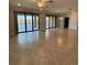 Spacious living room features tile flooring and sliding glass doors to a balcony with water views at 10054 Crooked Creek Dr # 201, Venice, FL 34293