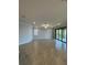 Expansive living area with tile flooring, neutral walls, and sliding glass doors to a balcony at 10054 Crooked Creek Dr # 201, Venice, FL 34293