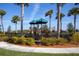 Community playground in the home development with palm trees at 10054 Crooked Creek Dr # 201, Venice, FL 34293