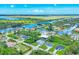Panoramic aerial view showcasing the neighborhood with waterfront canals and sprawling greenery at 10443 Riverside Rd, Port Charlotte, FL 33981