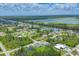 Aerial view displaying tranquil homes situated along a river, complemented by lush green landscape at 10443 Riverside Rd, Port Charlotte, FL 33981