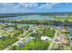 An aerial view showcases a community nestled along winding waterways, green landscape, and blue skies at 10443 Riverside Rd, Port Charlotte, FL 33981