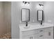 Bathroom featuring a double vanity with modern sinks, mirrors, and lighting at 10443 Riverside Rd, Port Charlotte, FL 33981