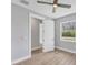 Bedroom featuring wood floors, a ceiling fan, and double-paned windows at 10443 Riverside Rd, Port Charlotte, FL 33981