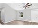 Bright bedroom with neutral walls, wood-look flooring, and a ceiling fan at 10443 Riverside Rd, Port Charlotte, FL 33981