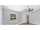 Bright, airy bedroom featuring wood-look flooring, neutral wall paint and a ceiling fan at 10443 Riverside Rd, Port Charlotte, FL 33981