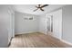 Bedroom featuring wood floors, a ceiling fan, a sliding glass door, and a closet at 10443 Riverside Rd, Port Charlotte, FL 33981