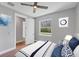 Bedroom features light grey walls, window, modern ceiling fan, and door at 10443 Riverside Rd, Port Charlotte, FL 33981