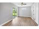 A light and bright bedroom with wood flooring, sliding glass door, and neutral walls at 10443 Riverside Rd, Port Charlotte, FL 33981