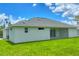A well manicured lawn highlights the home's exterior, leading to a covered back patio at 10443 Riverside Rd, Port Charlotte, FL 33981