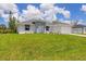 Charming single-story home featuring a well-manicured lawn and a two-car garage at 10443 Riverside Rd, Port Charlotte, FL 33981