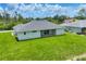 A beautiful, modern home nestled in a lush, green lawn on a sunny day at 10443 Riverside Rd, Port Charlotte, FL 33981
