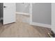 Hallway showing light wood-look floors and white trim at 10443 Riverside Rd, Port Charlotte, FL 33981