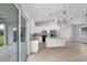 Open concept kitchen with a central island, stainless steel appliances, and sliding doors to the outside at 10443 Riverside Rd, Port Charlotte, FL 33981