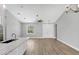 Light-filled living room with wood floors, modern light fixtures, a window, and a double door at 10443 Riverside Rd, Port Charlotte, FL 33981